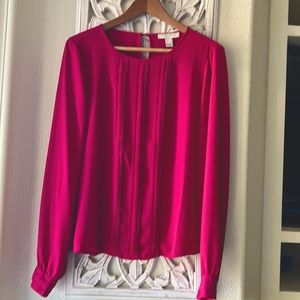 Fuscia colored blouse.